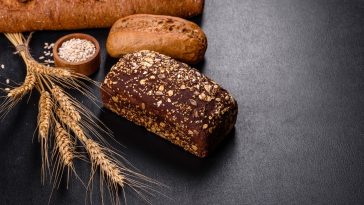 Fresh Bread on black background, top view, copy space